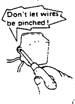 Cartoon mechanic with a pinched harness and a starburst note 'Don't let wires be pinched!', depicting making sure harnesses are not pinched after installing parts.