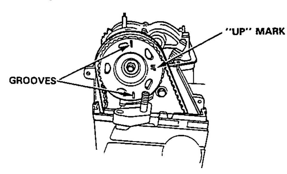 Number 2 piston at TDC: timing-belt pulley showing the "UP" MARK pointing to the intake side and the GROOVES.