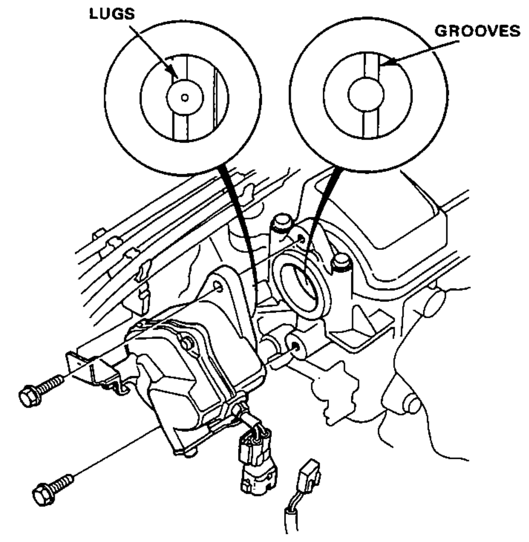 Engine-end view showing the sensor lugs and the mating camshaft-end grooves, both offset, plus the sensor being installed onto the engine.