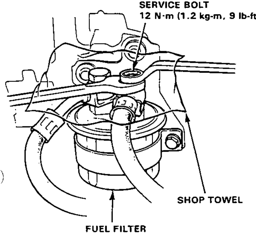 Underhood view of the fuel filter with a shop towel placed over the 6 mm service bolt at its top; the service bolt torque is called out.