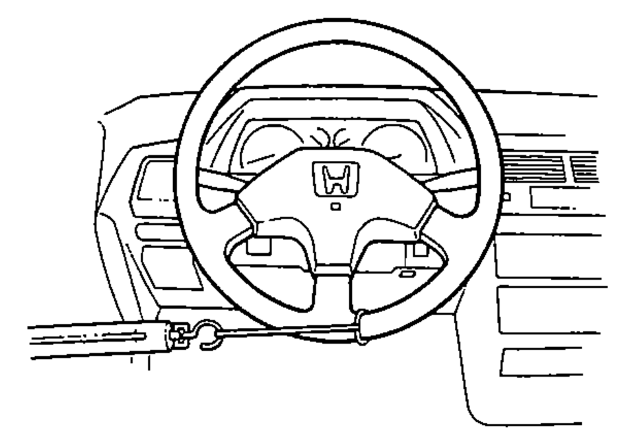 Steering wheel and dashboard with a spring gauge hooked to the wheel rim to measure steering effort.
