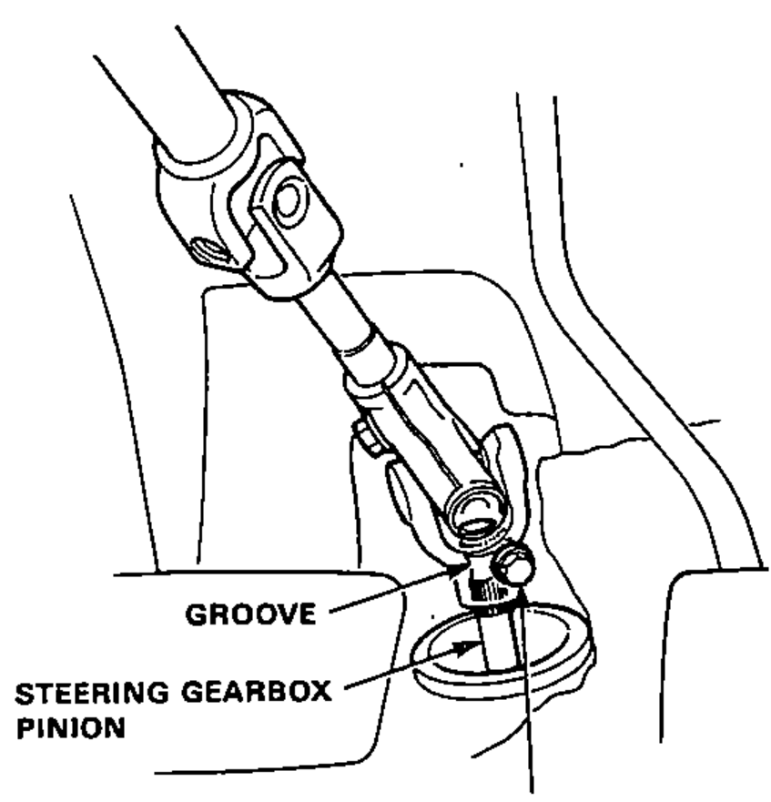 Steering joint loosely installed on the steering gearbox pinion, showing the lower bolt seated in the groove of the pinion.