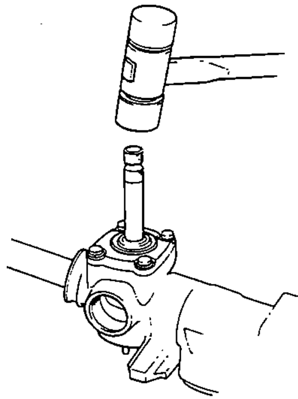 Pinion being removed from the gear housing by tapping it lightly with a soft-faced hammer.