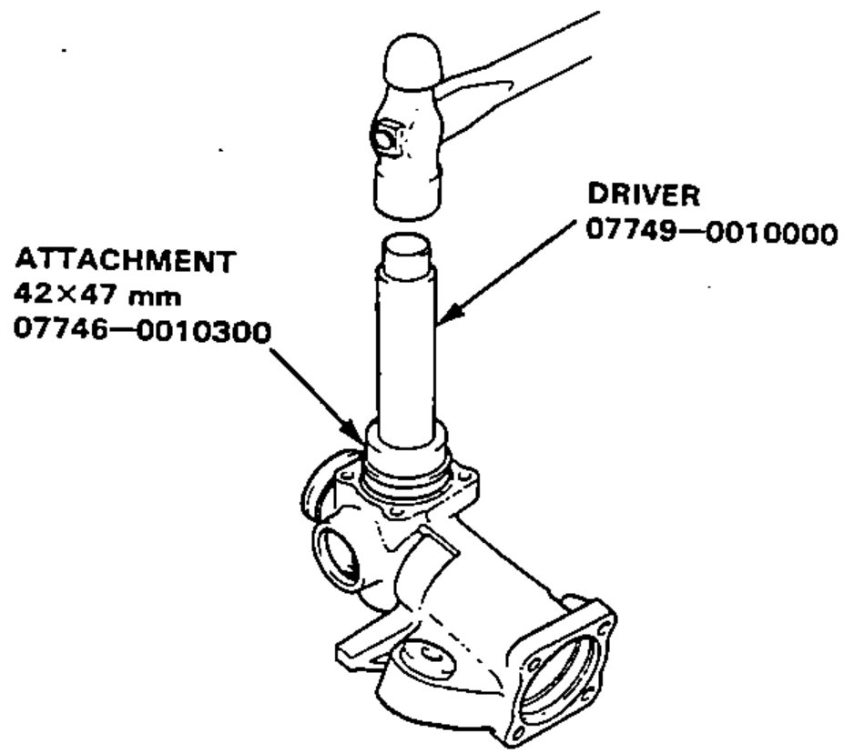 A new upper bearing being driven into the gear housing using the driver and attachment special tools.