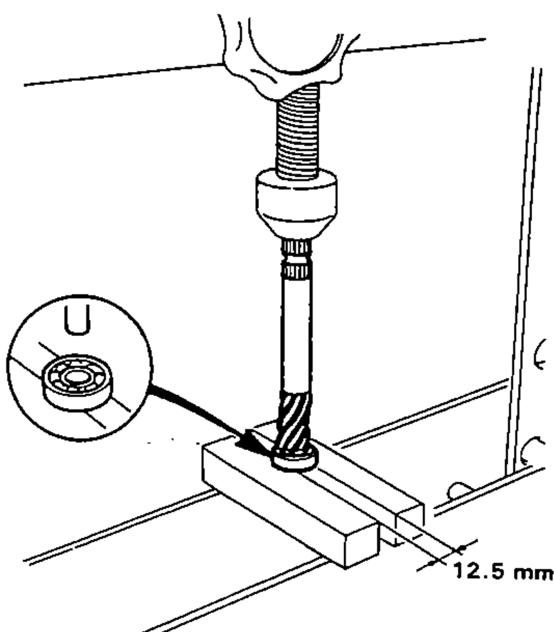 Pressing the lower ball bearing onto the pinion with shielded side facing down, using a press and a 12.5 mm support; inset shows the bearing orientation.