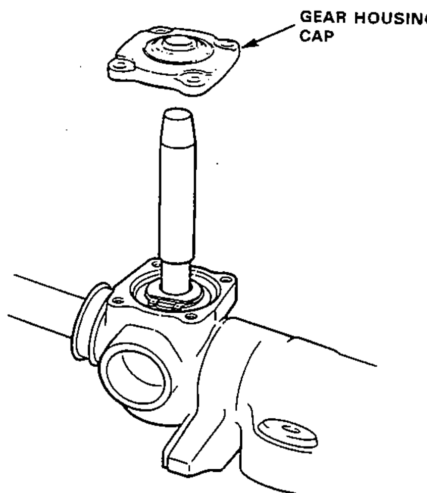 Installing the gear housing cap over the steering pinion on the gear housing.