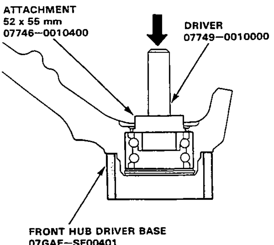 Pressing the wheel bearing out of the knuckle with a driver and attachment on a hydraulic press, knuckle supported on the front hub driver base.