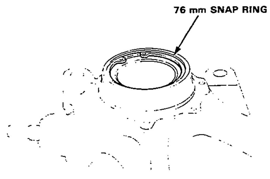 Installing the 76 mm snap ring securely in the knuckle groove.