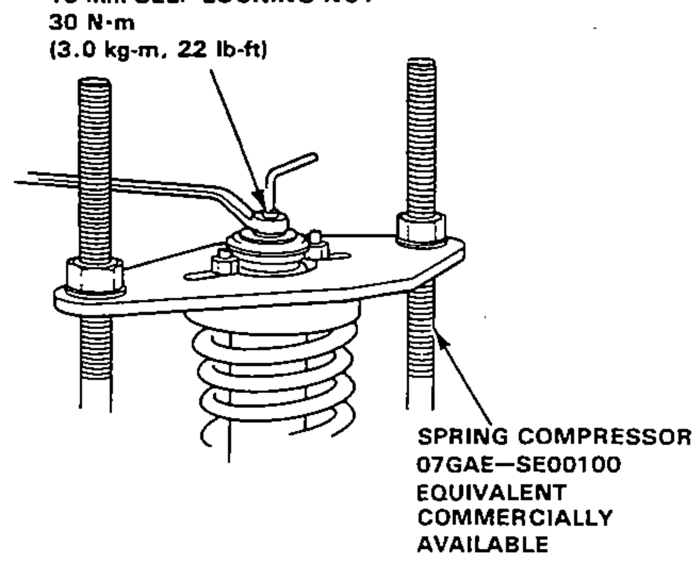 Damper shaft held on the spring compressor plate while installing the damper mount washer and tightening the 10 mm self-locking nut.