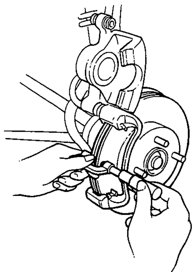 Hands using a micrometer to measure brake disc thickness with the caliper and pads moved out of the way.