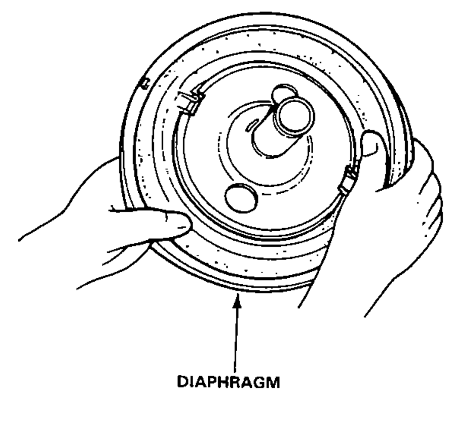 Two hands installing the diaphragm onto the booster piston.