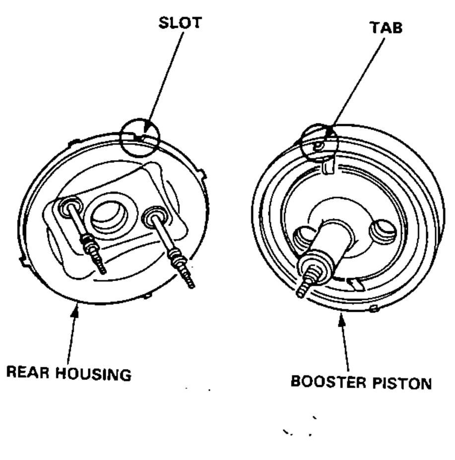 Two views of the booster piston installed on the rear housing, showing the alignment of the slot and tab.