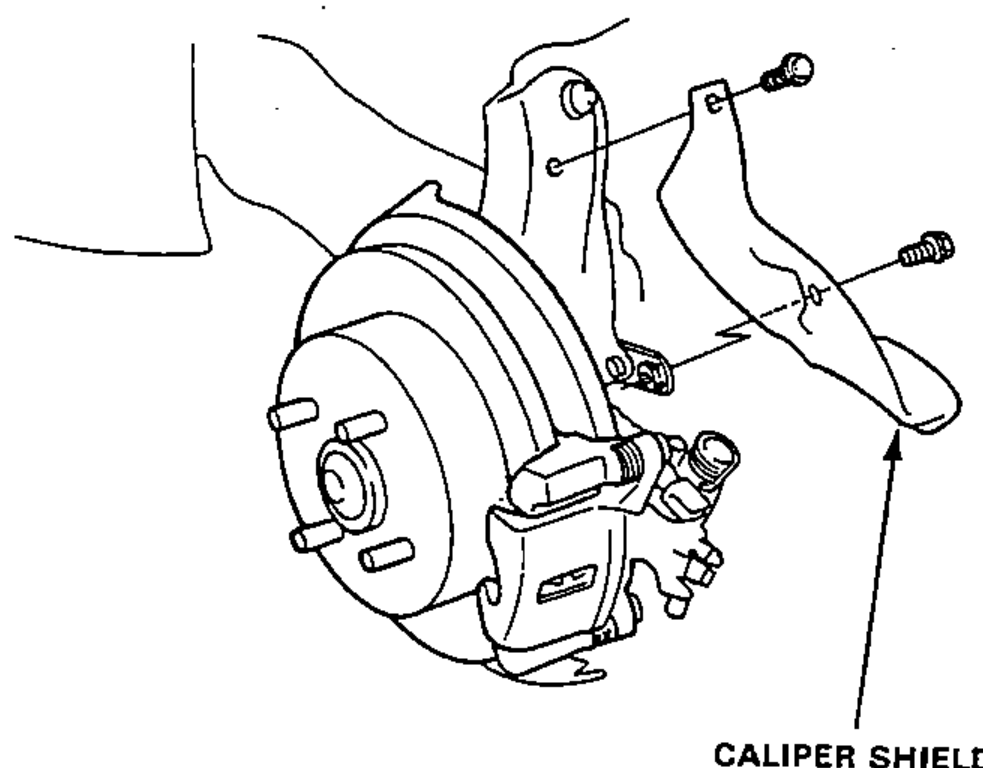 Rear brake assembly with the caliper shield being removed; arrows show the shield mounting bolts.