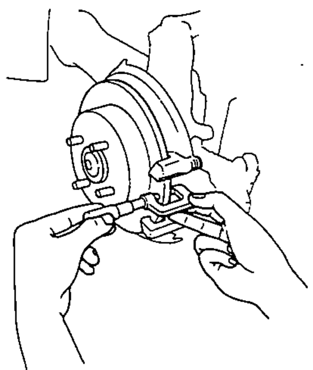 Using a micrometer to measure the rear brake disc thickness at eight points around the disc.