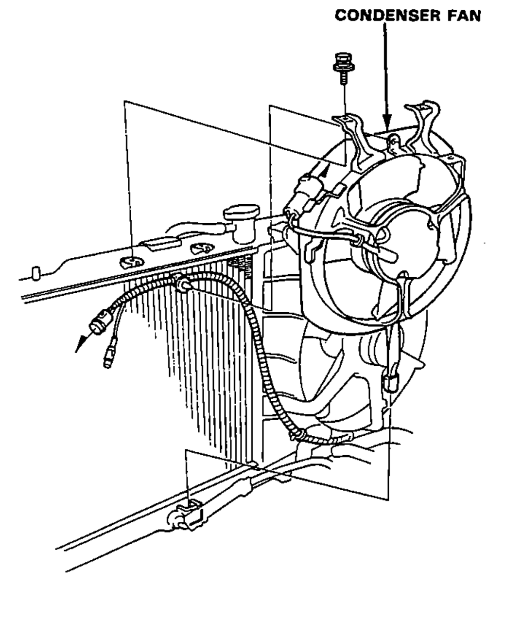 Condenser fan assembly at the front of the radiator with its two mounting bolts, viewed for removal.