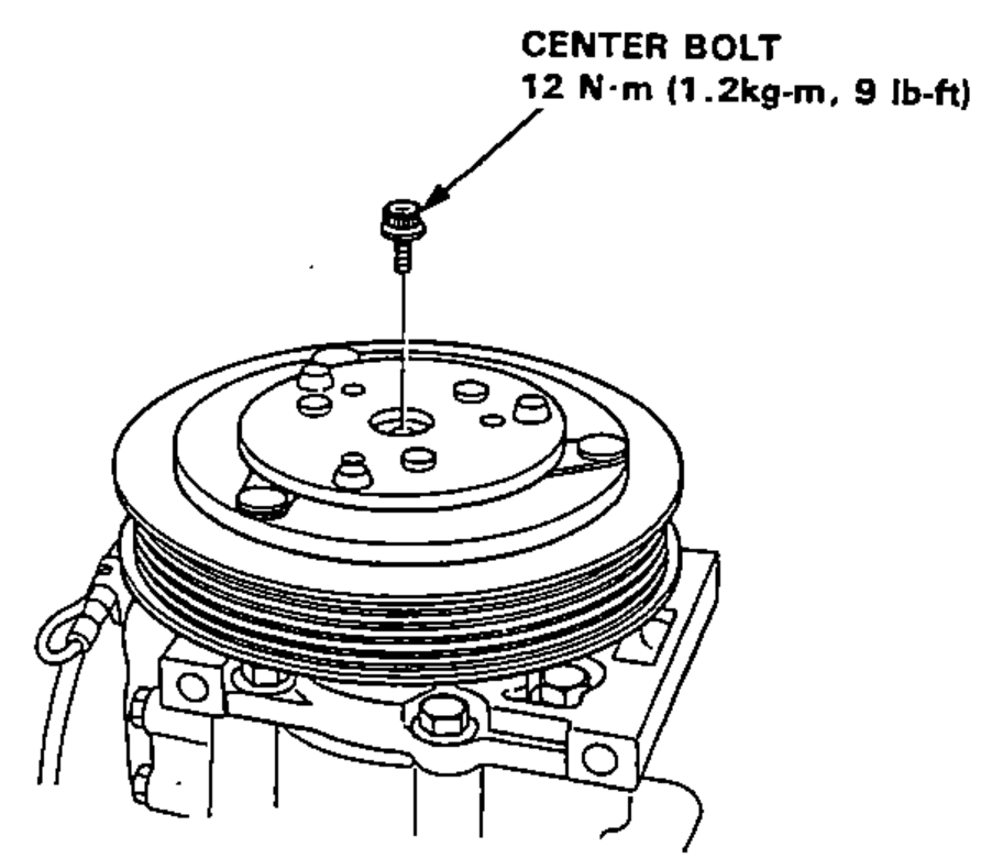 Removal of the center bolt and washers from the compressor clutch pressure plate. Leader line points to the center bolt at top center.