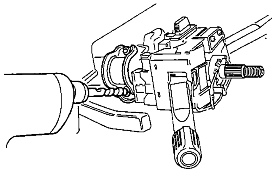 Steering column showing the ignition switch/lock body assembly and the shear bolts being removed from the switch body after drilling off the heads.